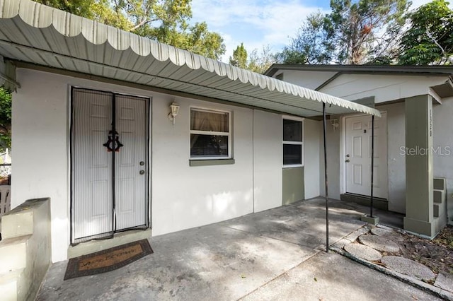 entrance to property featuring a patio area