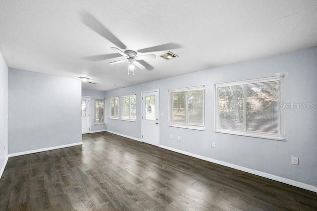 spare room with ceiling fan, a textured ceiling, and dark hardwood / wood-style floors