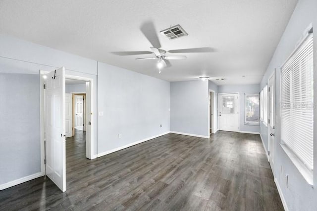 empty room with ceiling fan and dark hardwood / wood-style floors