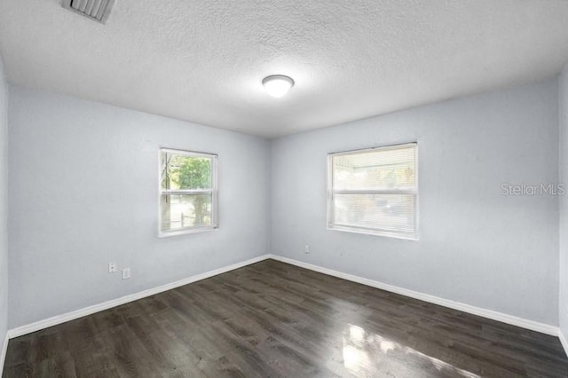 empty room with dark wood-type flooring