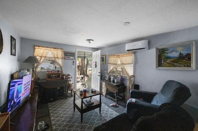 living room with a textured ceiling and a wall unit AC