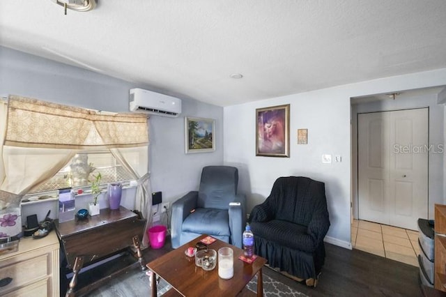 living area with dark wood-type flooring, a textured ceiling, and a wall unit AC