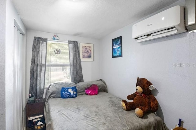 bedroom featuring a wall unit AC