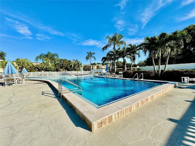 view of swimming pool with a patio