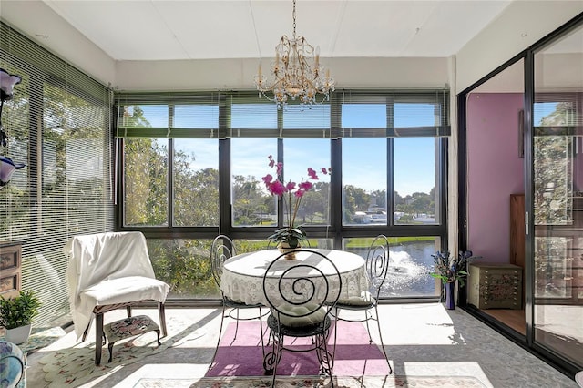 sunroom / solarium with an inviting chandelier