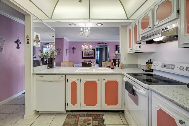 kitchen with light tile patterned flooring, white appliances, a notable chandelier, and sink