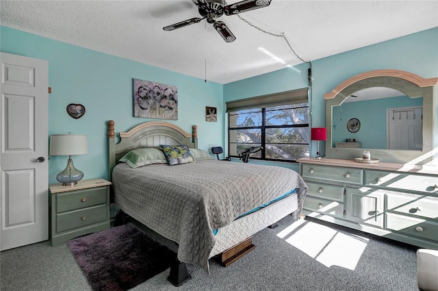 carpeted bedroom with a textured ceiling and ceiling fan