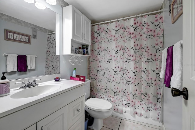 full bathroom featuring shower / bath combo with shower curtain, tile patterned flooring, vanity, and toilet