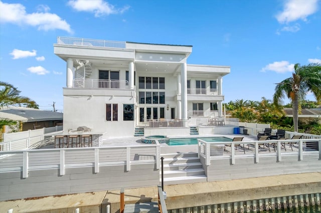 rear view of property featuring a balcony, outdoor lounge area, and a patio