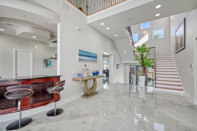 interior space featuring tile patterned floors and a high ceiling