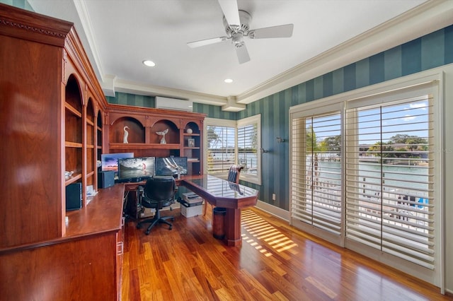 office with ceiling fan, a wall mounted AC, crown molding, and wood-type flooring