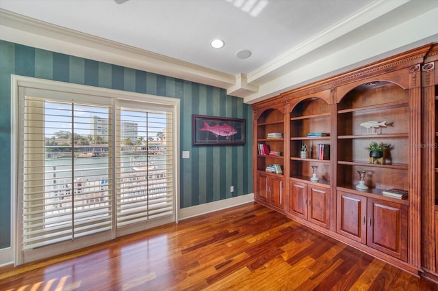 interior space featuring dark wood-type flooring and ornamental molding