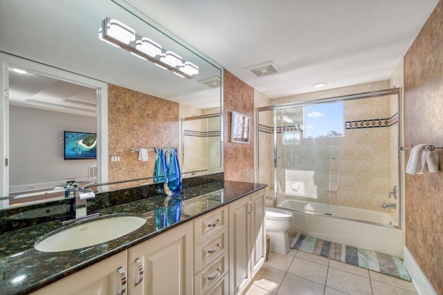 full bathroom with shower / bath combination with glass door, toilet, tile patterned flooring, and vanity