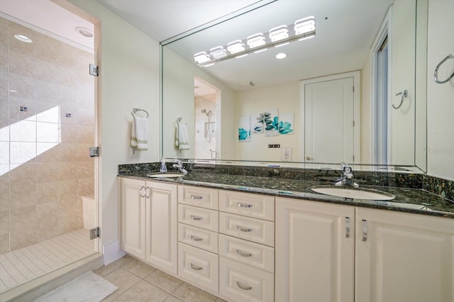 bathroom with tile patterned flooring, an enclosed shower, and vanity