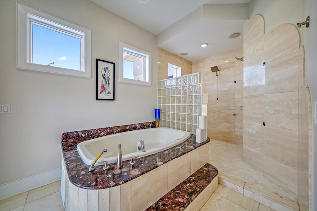 bathroom with tile patterned flooring and shower with separate bathtub