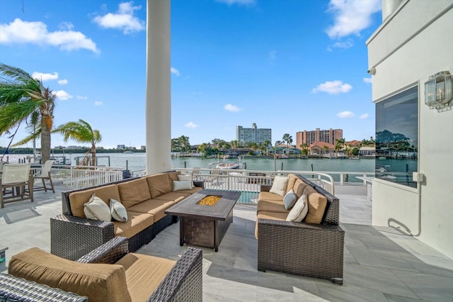 view of patio / terrace with an outdoor living space with a fire pit and a water view