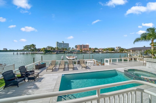 view of swimming pool featuring an in ground hot tub, a patio area, and a water view