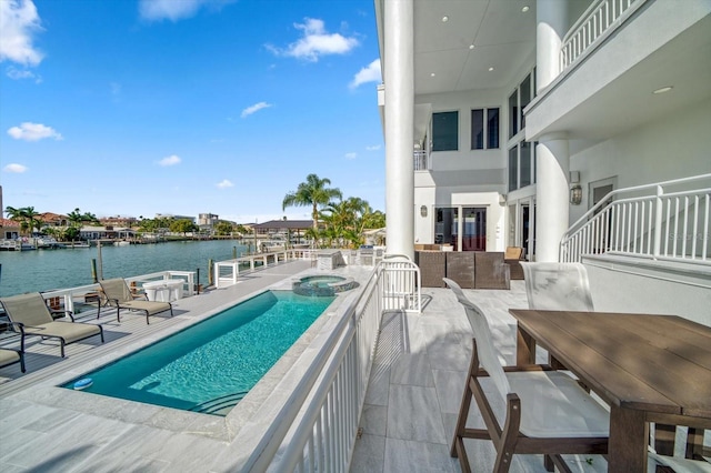 view of pool with a patio and a water view