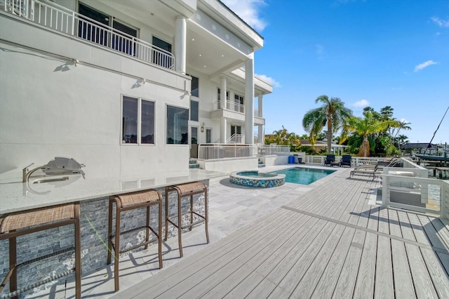 view of swimming pool with exterior bar and a patio area