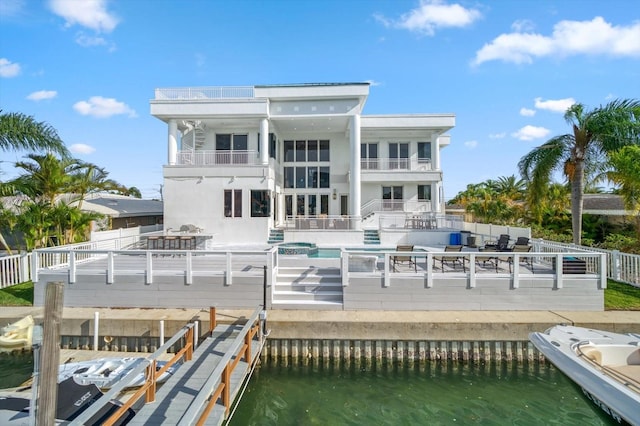 back of house with a balcony and a water view