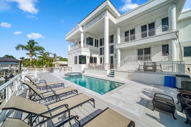 view of swimming pool featuring an in ground hot tub and a patio