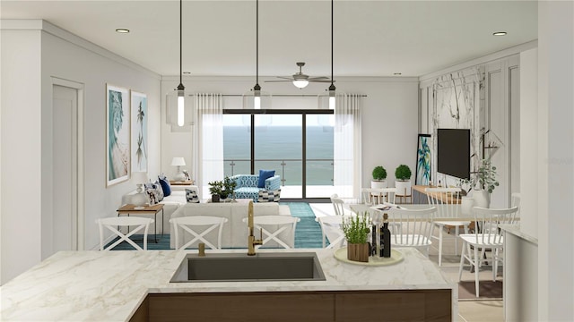 kitchen featuring sink, ceiling fan, ornamental molding, and pendant lighting