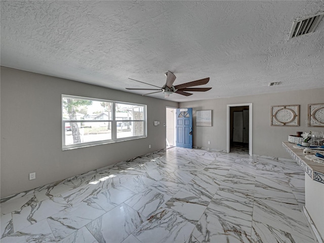 unfurnished living room featuring ceiling fan