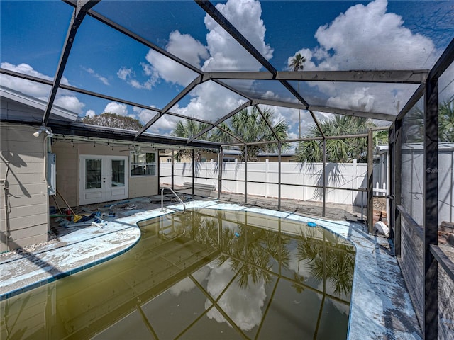 view of swimming pool with a lanai and french doors