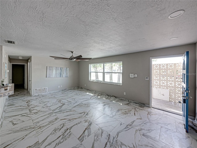 unfurnished living room with ceiling fan