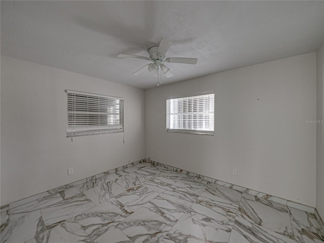 spare room with ceiling fan