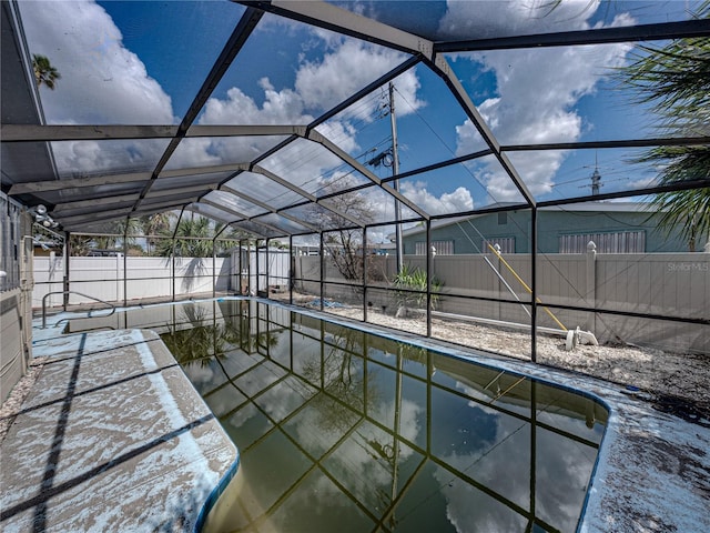 exterior space with a lanai and an empty pool