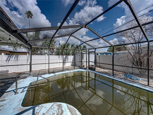 view of swimming pool featuring a lanai