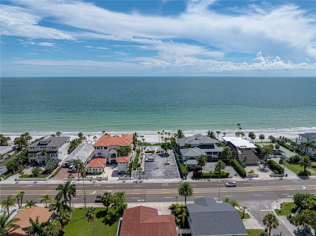 bird's eye view featuring a water view and a beach view