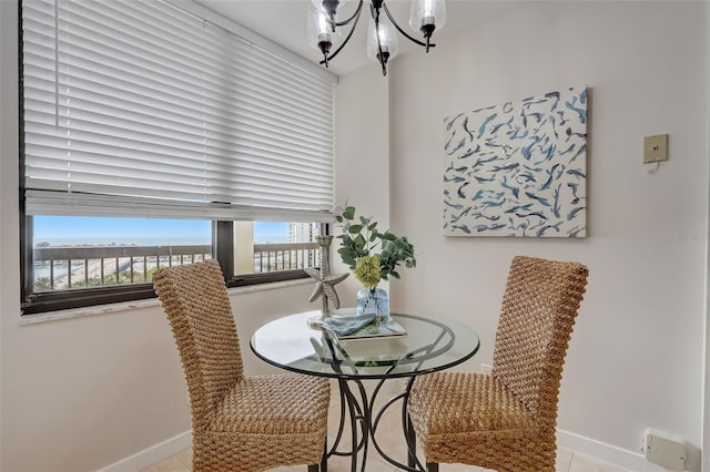 dining area with a notable chandelier and baseboards