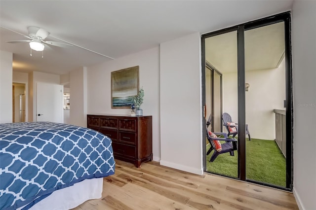 bedroom featuring light wood finished floors and baseboards