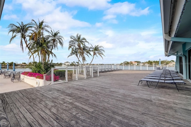 wooden deck with a patio area and a water view