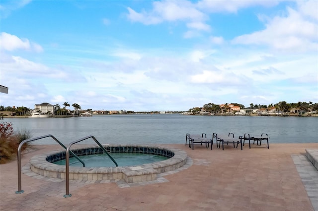 view of pool featuring a water view and a community hot tub