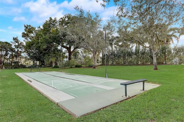 surrounding community featuring shuffleboard and a yard