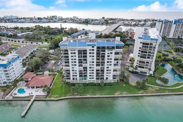 birds eye view of property with a water view and a city view