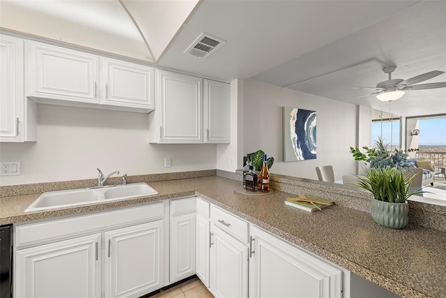 kitchen with a sink, visible vents, and white cabinetry