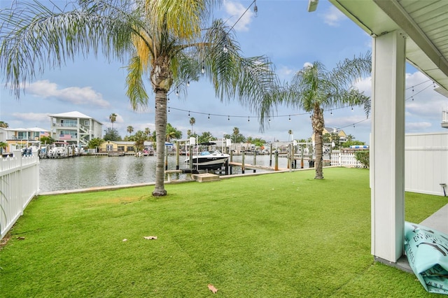 view of yard featuring a water view and a dock