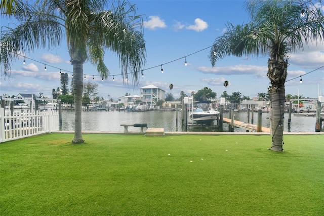 view of yard with a boat dock and a water view