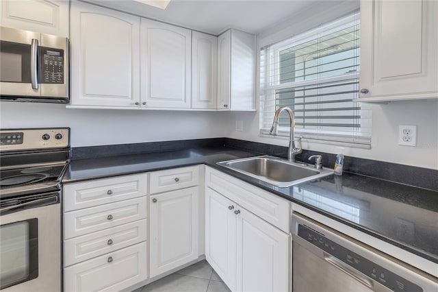 kitchen with dishwasher, light tile floors, sink, electric range oven, and white cabinetry