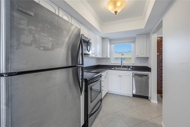 kitchen featuring stainless steel appliances, sink, white cabinetry, and a raised ceiling