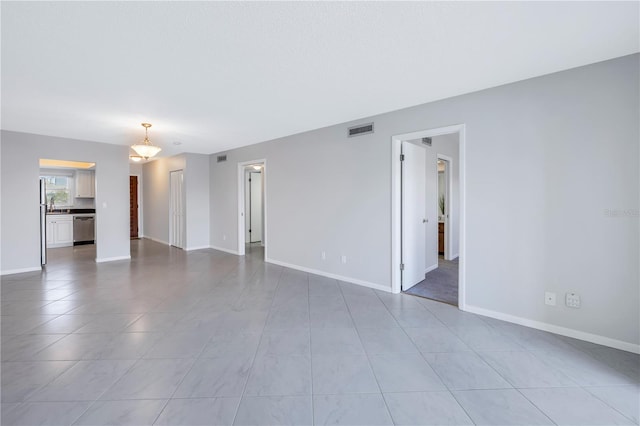 spare room featuring tile floors