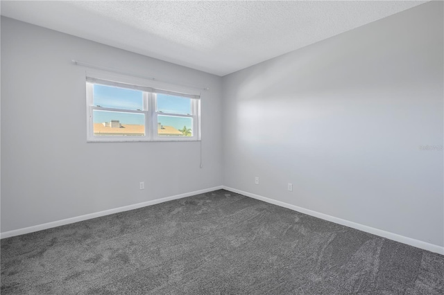 carpeted spare room featuring a textured ceiling