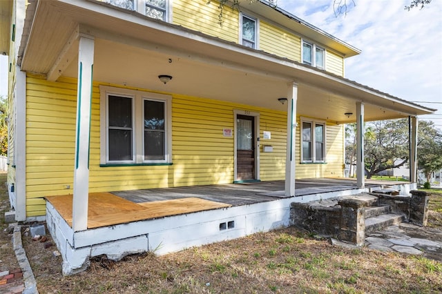 back of property with a porch