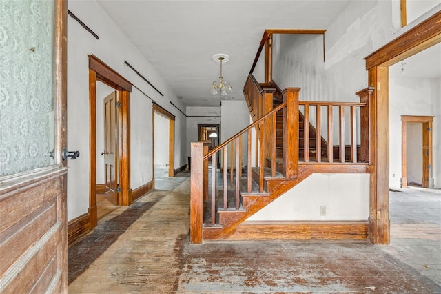 stairs with an inviting chandelier