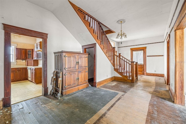 foyer featuring a notable chandelier, wood-type flooring, and a wealth of natural light