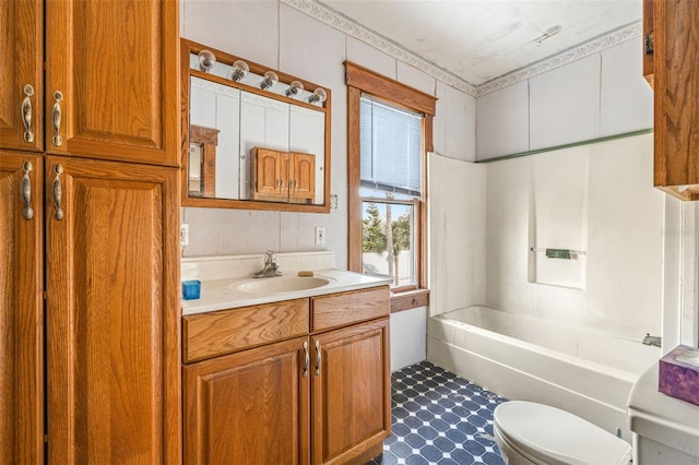 bathroom with a washtub, vanity, and toilet